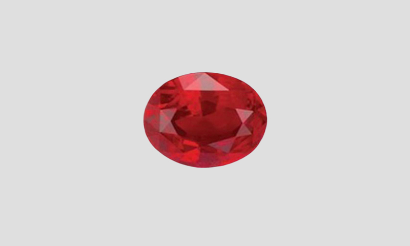 deep red heated sapphire oval cut on a dark background